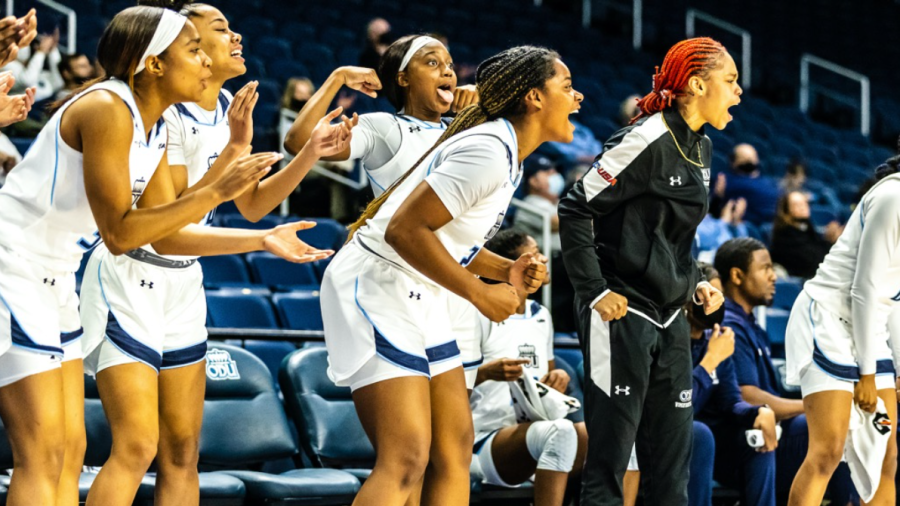 The Lady Monarchs celebrate on the bench after another score. 