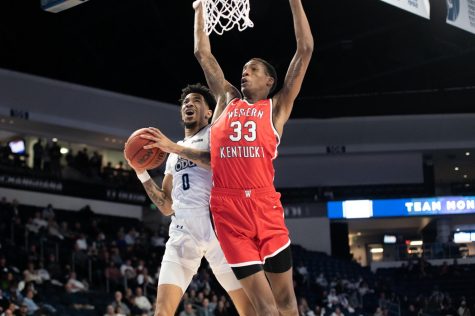 Mekhi Long #0 goes up for the layup as a WKU defender guards him.