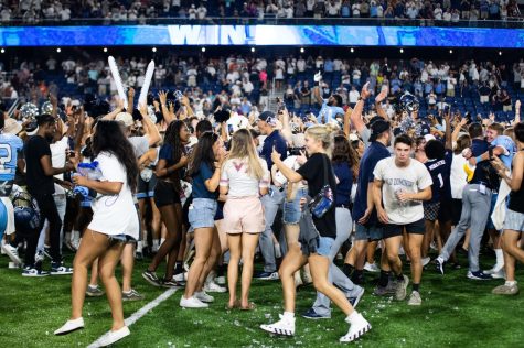 ODU students and football team celebrate at midfield after the victory over Virginia Tech. 