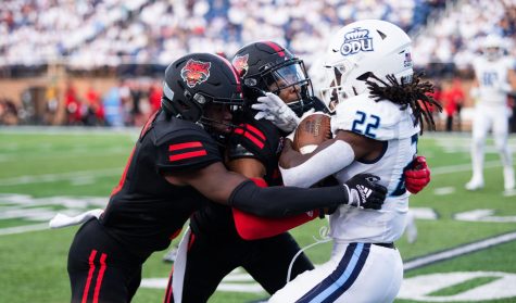 Redshirt Sophomore RB Keshawn Wicks goes head on with two Red Wolve defenders on the run