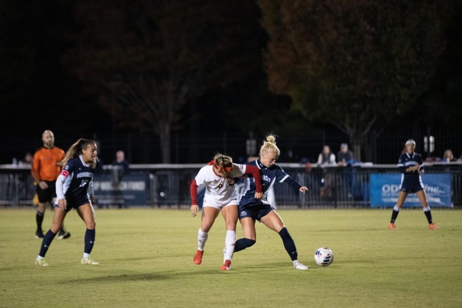 Senior Emma Terefenko wrestles with the Red Wolves attacker for possession of the ball.