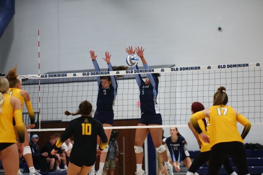 Bailey Burgess and Teresa Atilano go up for the block in their matchup against App State on Friday night. 