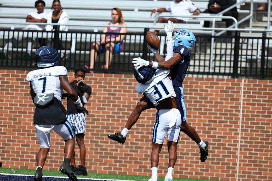 Junior wide receiver Javon Harvey makes the one-handed leaping catch over freshman B.J. Lowry Jr. 