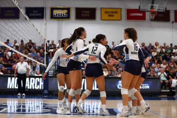 Lady Monarchs come together after scoring a point in their match against VCU.  