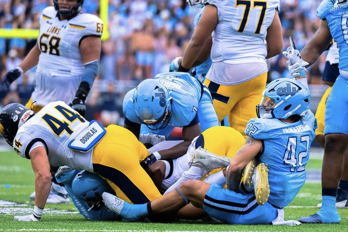 Junior LB Jason Henderson grabs ahold of the Lions ball carrier for a tackle-for-loss. 