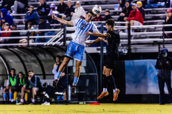 Sophomore forward Michael Eberle goes up for the header in his match against UCF.