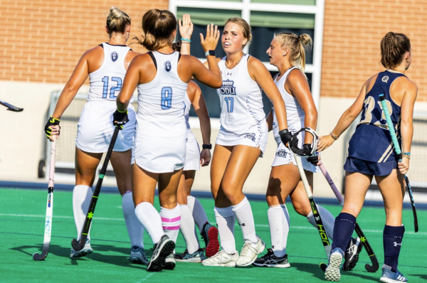 Lady Monarchs celebrate after their goal against George Washington earlier this season. 