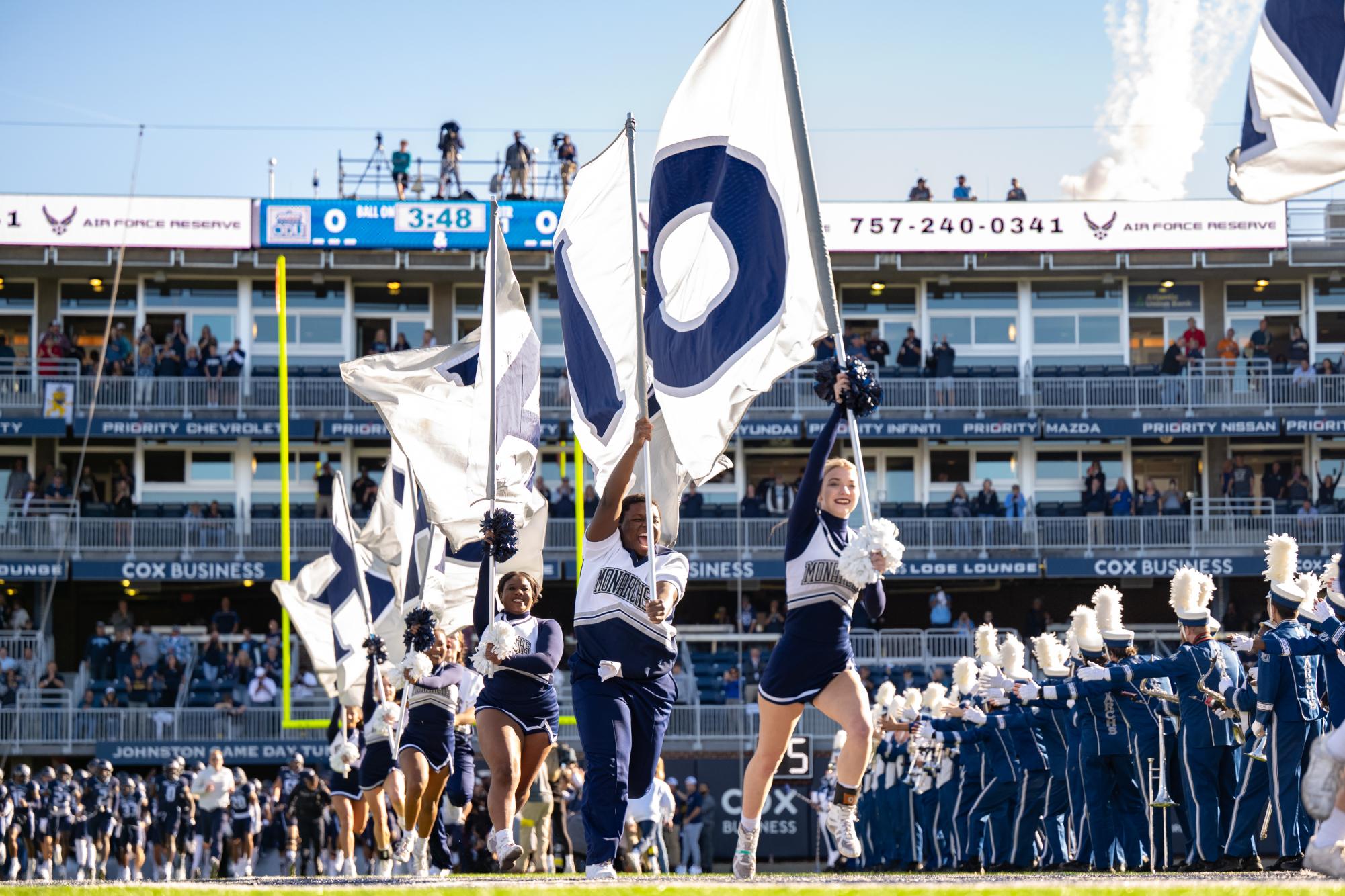 ODU Cheerleaders lead the charge as the Monarchs make their entrance.
