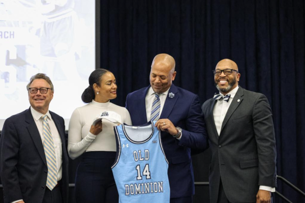 Head coach Mike Jones and his wife Stayce pose for a photo with President Brian O. Hemphill and Dr. Wood Selig at his introductory press conference. 