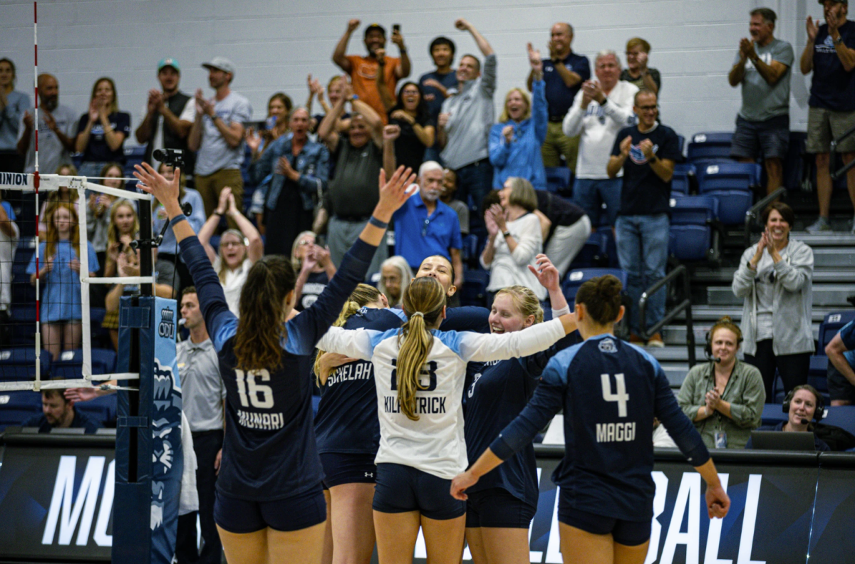 Lady Monarchs come together to celebrate in match against Coastal on Friday. 