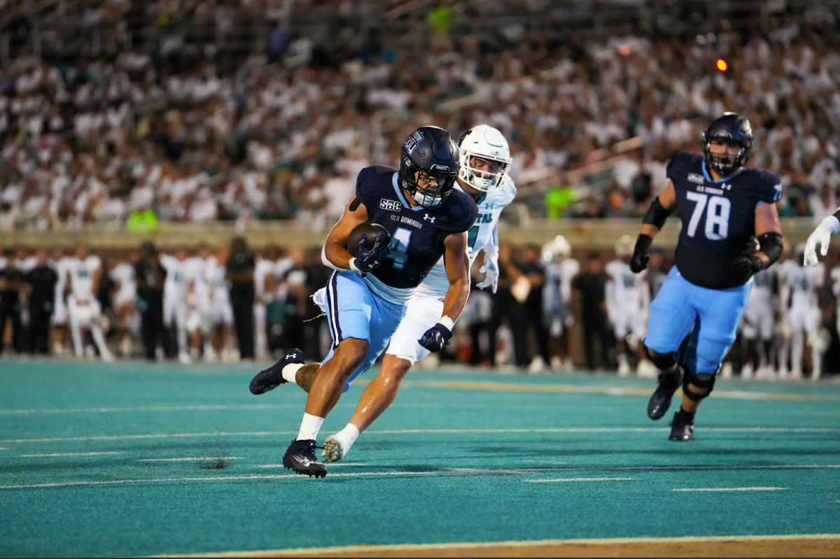 Junior running back Bryce Duke rushes his way into the end zone against Coastal on Saturday. 